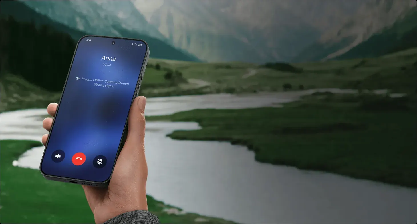 Smartphone Xiaomi tenu en main devant une vallée de montagne